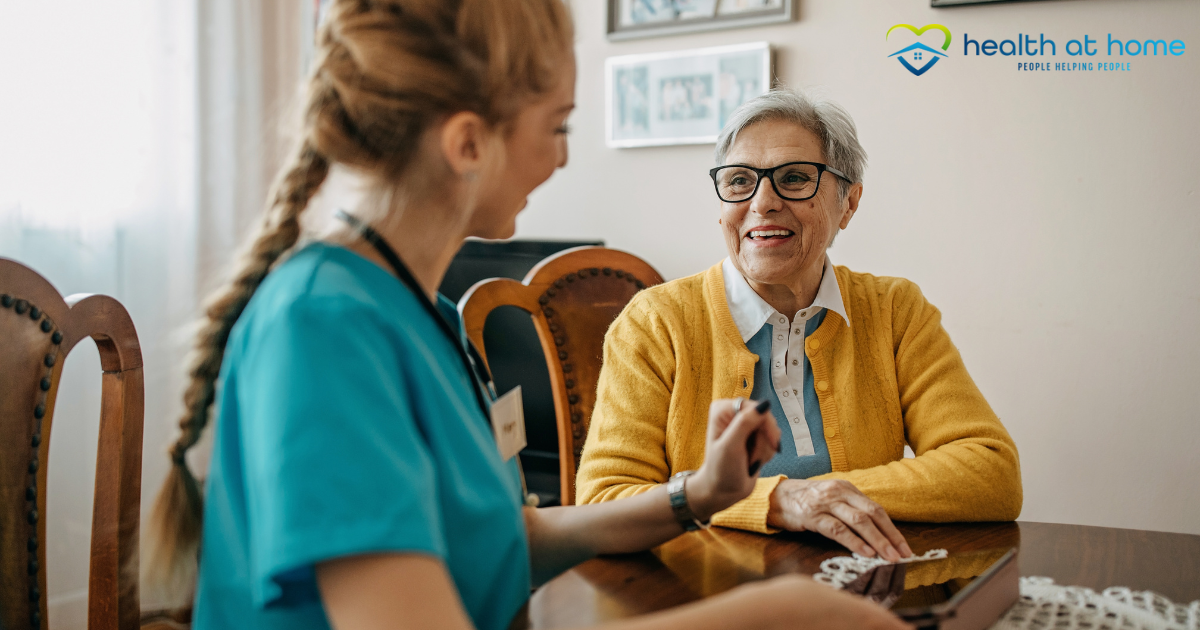 A senior woman enjoys the benefits of private duty care as her caregiver checks in on her.