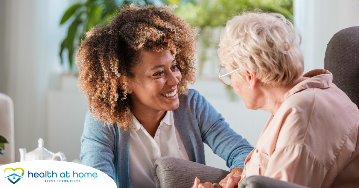 A woman enjoys compassionately providing caregiving services to an elderly woman.