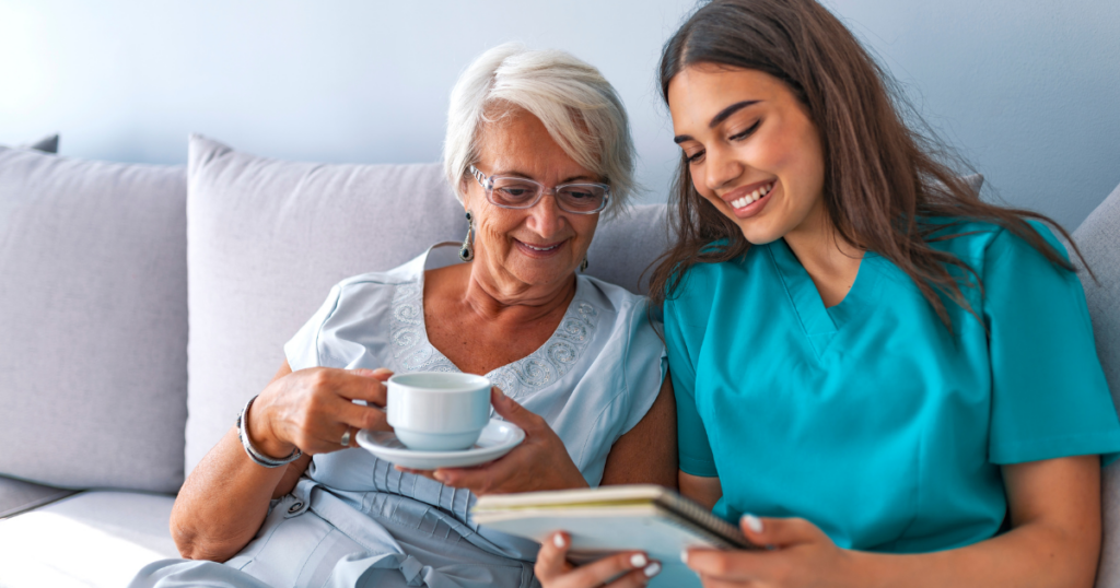 A caregiver and client smile as they go over a notebook, representing the good results of home care in Sandalfoot Cove, FL.